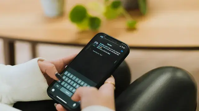 Person typing a question into an AI chat app on a phone